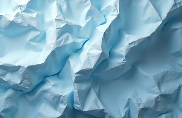 Obraz premium Abstract image featuring crumpled light blue paper texture with folds, wrinkles. Paper sheet background, artistic, creative backdrop for design, art projects, presentations, websites. Blank space for