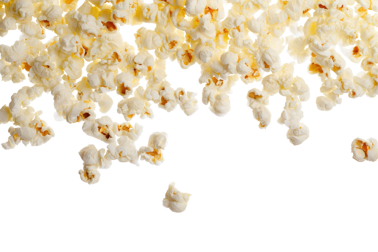 A close up view of popcorn pieces scattered with a black background creating a dynamic food image effect