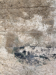 Worn beige facade with holes