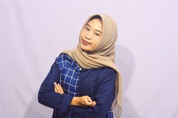 Beautiful young student girl wearing green student t-shirt smiling happily pointing with hand and finger to the side on isolated purple background