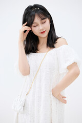 Fototapeta premium Studio shot of beautiful Asian woman in white dress