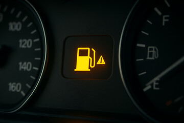 Empty fuel warning light on modern car dashboard close-up