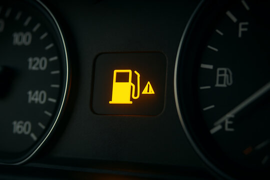 Empty fuel warning light on modern car dashboard close-up