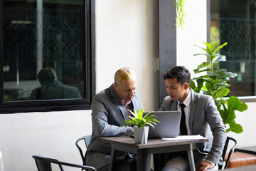 Business meeting : Business colleagues talking in the office. Group of business man talking in modern office building