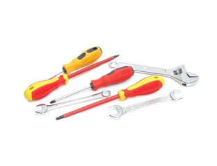 Tools equipment, wrenches, screwdrivers, yellow and red handles with black stripes placed on a...