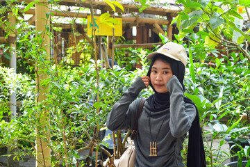 Young Indonesian woman smiling happily. enjoy time in the park