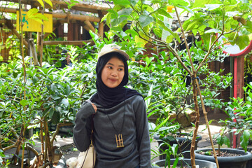 Young Indonesian woman smiling happily. enjoy time in the park