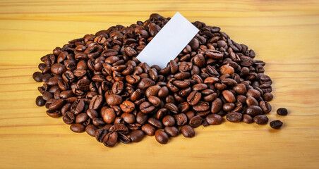 Coffee beans with blank label mockup on rustic wood surface