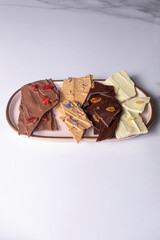 Chocolate chips of different flavors on a platter_vertical.