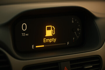 Close-up of modern digital car display with empty fuel alert icon