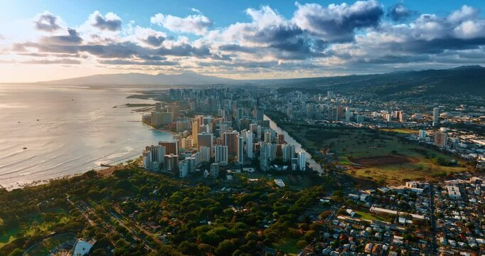 Spectacular scenery of Honolulu, Hawaii, USA at sunset. Grey cumulus clouds gather over the panorama of the city.