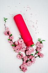 Shampoo, hair conditioner in a red jar on a white background. Mockup, space for text. Sakura...