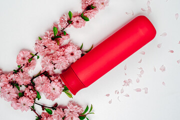 Shampoo, hair conditioner in a red jar on a white background. Mockup, space for text. Sakura...