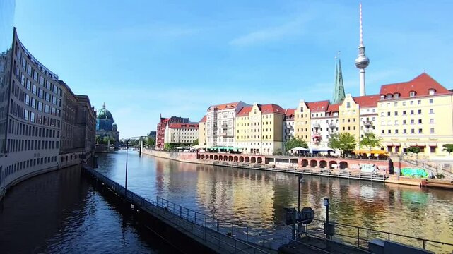 Calming video of the Spree River on a beautiful spring morning in Berlin, Germany, featuring the charming Nikolaiviertel quarter and the iconic Berliner Dom in the distance.