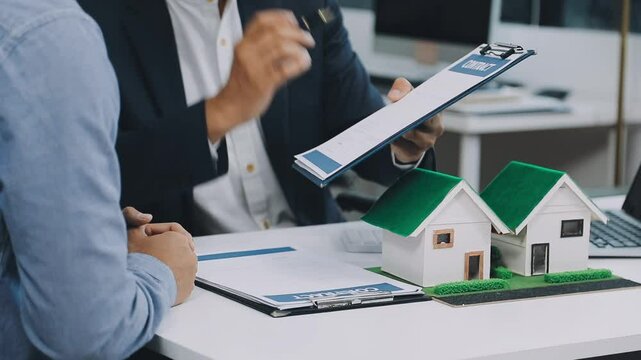 Lawsuits against Real estate agent and realtor general liability insurance businessman professional discussing and consultant with house toy model building before sign a contract with law concept