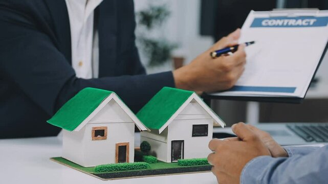 Lawsuits against Real estate agent and realtor general liability insurance businessman professional discussing and consultant with house toy model building before sign a contract with law concept