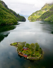 Stunning view of a tranquil island with red cabin surrounded by dramatic Norwegian fjords