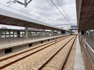 Empty Modern Train Station Platform and Railway Tracks