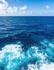 Obraz premium A serene view of the vast ocean stretches out from an open boat, with gentle waves lapping against the hull under a clear blue sky.