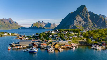 Fotobehang Coastal village nestled among Lofoten mountains in Reine, Norway, with colorful houses and boats © Fokke Baarssen