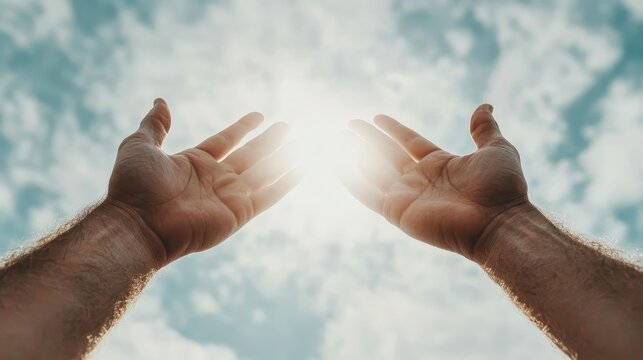 An evocative image of hands reaching upwards toward bright sunlight shining through clouds, representing aspiration, hope, and the deep connection between humans and the universe.