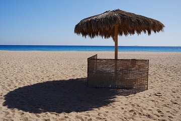 Sunbathing place with umbrella on beach at Red Sea in African SAFAGA city in EGYPT