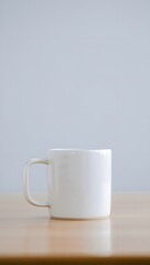 Obraz premium Minimalist White Ceramic Mug on Wooden Table