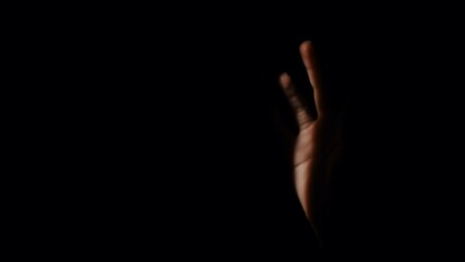 Artistic Portrait of a Hand Emerging from Darkness