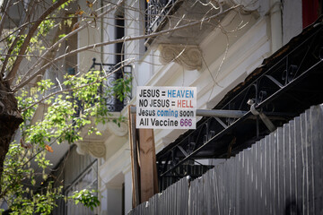 A sign, located in the city opf Athens, Greece, stating a religious belief and stating that all...