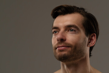 Naklejka premium Portrait of a Man with Short Hair and Earrings