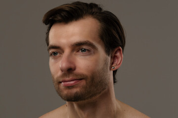 Fototapeta premium Portrait of a Man with Short Hair and Earrings