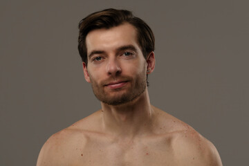 Naklejka premium Portrait of a Man with Short Hair and Earrings