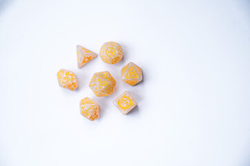Set of yellow role-playing dice on a white background. Multi-sided dice (d4, d6, d8, d10, d12 and d20) for fantasy games.