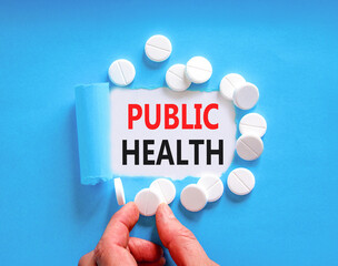 Public health symbol. Concept words Public health on beautiful white paper. White pills tablets. Doctor's hand. Beautiful blue background. Medical healthy lifestyle public health concept.