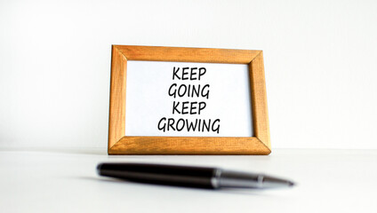 Keep going and growing symbol. Concept words phrase Keep going keep growing on beautiful wooden...