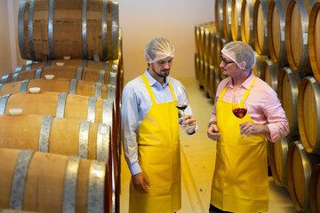 sommelier : portrait of sommelier holding glass and drink wine check process of make wine. Wooden...