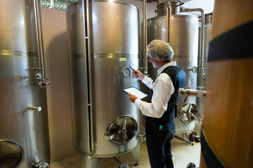 winemaker : Two professional winemaker working inspection process of make wine at modern wine...