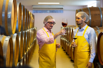 winemaker : Two professional winemaker working inspection process of make wine at traditional wine...