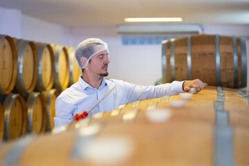 winemaker : Two professional winemaker working inspection process of make wine at traditional wine...