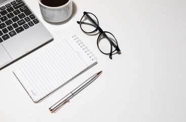 Minimalist Office Setup – Laptop with Supplies on White Table