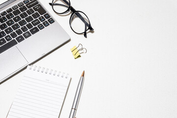 Top-Down View of Creative Workspace – Laptop and Office Accessories on White Desk