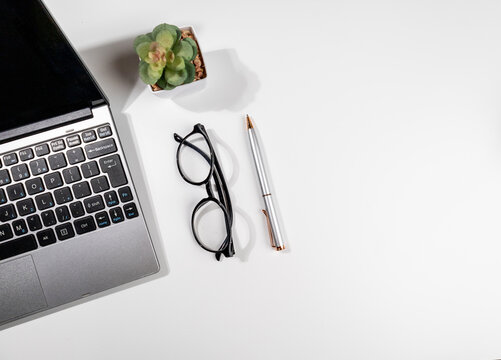 Modern Workspace Essentials – Top View of White Desk with Laptop and Office Supplies
