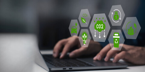 A business person using laptop with ESG environment social governance investment business concept, co2 on visual screen.