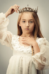 Young Girl Holding Her Crown