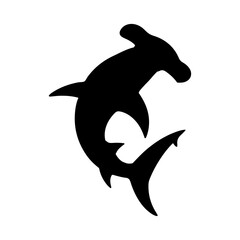 Silhouette of a hammerhead shark swimming gracefully in the ocean water with its unique head shape shown