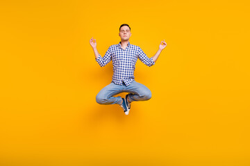 Full length portrait of jumping calm focused guy meditating relaxation isolated over pastel color background