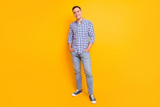 Full length portrait of his he nice attractive content cheerful guy isolated over yellow color background