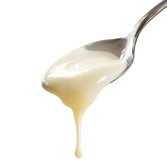 A close-up shot of a spoon with flowing of condensed milk. A trickle of milky goodness is gracefully dripping from the spoon