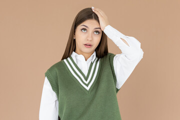 Gosh why me. Portrait of unhappy and annoyed young arrogant woman in green vest facepalming with...