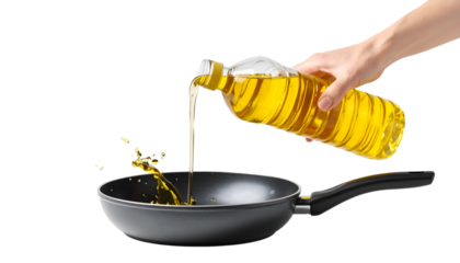 Hand pouring cooking oil into a black pan on a white background. Perfect for food media.